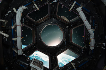 Fototapeta premium Fascinating sunrise on earth. Spaceship window view. Elements of this image furnished by NASA.