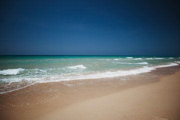 Mediterranean beach with turquoise water in sunny weather