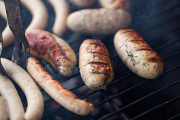 Cooking sausages on the barbecue grill. Grilled sausages. 