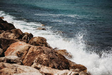 Fototapeta na wymiar the waves of the sea beat against the stones