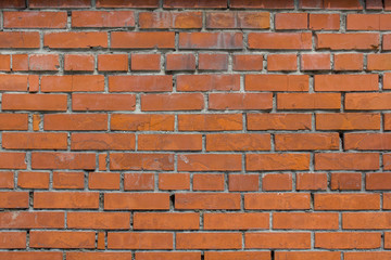 old red yellow wall of cracked bricks with light cement. rough surface texture