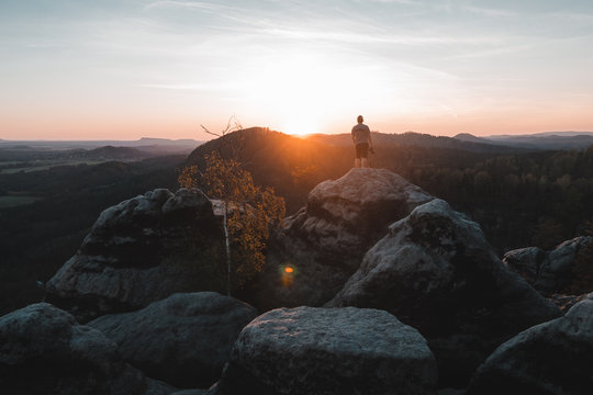 A tourist guy and beautiful morning sunrise of the Mariina Viewpoint, Bohemian Switzerland, National Park Bohemian Switzerland, Czech republic