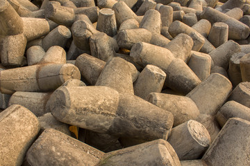 many gray concrete tetrapods close up, tsunami barrier