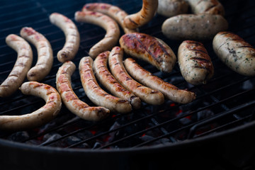 Fototapeta premium Cooking sausages on the barbecue grill. Grilled sausages. 