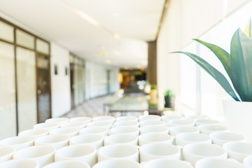 Fototapeta premium Stack of clean dishes plates and cups on a table prepared by the catering service for the event. 