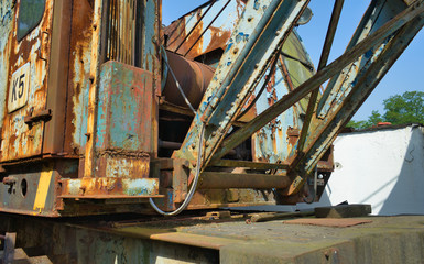 Old rusty railway crane on the siding