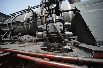 Black hydraulic brake cylinder of a historic locomotive