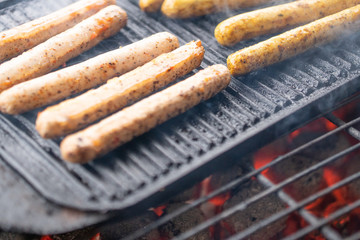 Cooking sausages on the barbecue grill. Grilled sausages