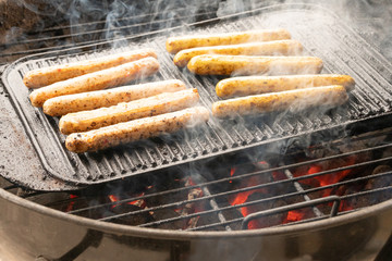 Cooking sausages on the barbecue grill. Grilled sausages