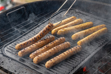 Cooking sausages on the barbecue grill. Grilled sausages