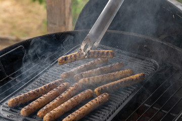 Cooking sausages on the barbecue grill. Grilled sausages