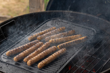 Cooking sausages on the barbecue grill. Grilled sausages