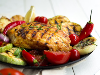 Grilled chicken breasts with vegetables