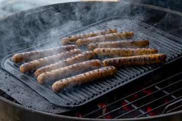 Cooking sausages on the barbecue grill. Grilled sausages