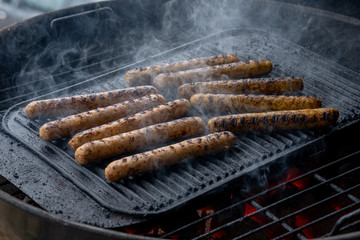 Cooking sausages on the barbecue grill. Grilled sausages