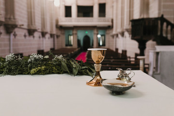 goblet of wine on table during a wedding ceremony nuptial mass. Religion concept. Catholic eucharist ornaments for the celebration of the Eucharist