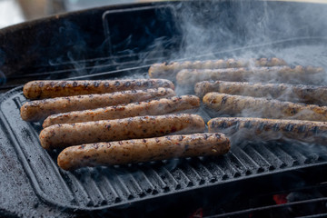 Cooking sausages on the barbecue grill. Grilled sausages