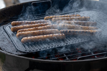 Cooking sausages on the barbecue grill. Grilled sausages