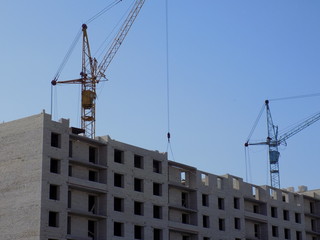 Fototapeta premium Construction of new houses. Works construction equipment - crane.