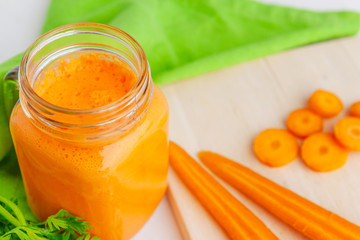 Carrot smoothie with parsley on a table