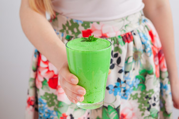 Woman holding bottle with delicious smoothie close up
