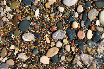 Stone natural background. Wet pebble stones in water.