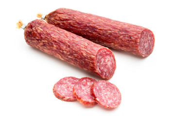 Salami smoked sausage, basil leaves and peppercorns isolated on white background.