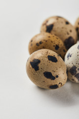 selective focus of quail eggs on white surface