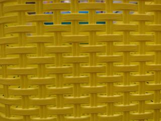 Artificial yellow plastic mesh, background texture.