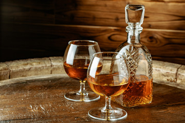 Cognac or whiskey in glasses on rustic backgrpund