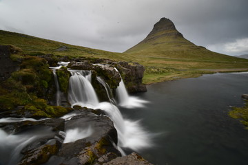 Famous kirkjufell mountain with the kirkjufell falls waterfalls in front in Grundarfjödur in Iceland