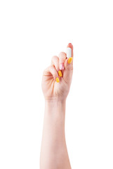 Woman's hand with a pill on a white background