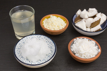 variety of coconut products: milk, puree, pieces, oil, flakes and pieces of coconut