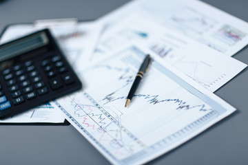 Naklejka na ściany i meble close up.pen, financial chart and calculator on the desktop