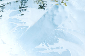 Cleaning mirror, reflected blue sky and clouds