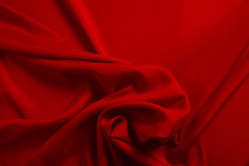 Red silk or satin luxury fabric texture can use as abstract background. Top view.