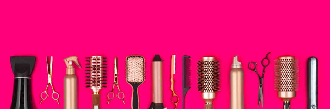 Professional hair dresser tools on red background with copy space