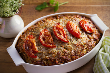 Beef rice and cabbage casserole in white baking dish on wooden table