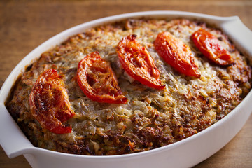 Beef rice and cabbage casserole in white baking dish on wooden table