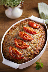 Beef rice and cabbage casserole in white baking dish on wooden table