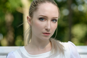 Outdoor portrait of beautiful young woman. Natural light.