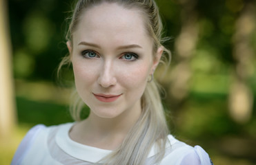 Fototapeta premium Outdoor portrait of beautiful young woman. Natural light.
