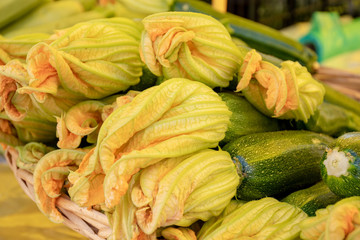 Fresh zucchini flower or courgettes in a farmer agricultural open air market, seasonal healthy...