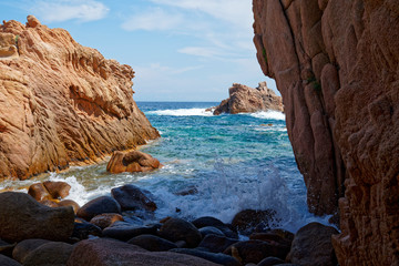 Rugged rock formation at a turquoise beach at La Sorgente, Costa Paradiso in Sardinia (Italy) with turquoise blue sea