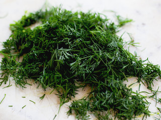 sliced fresh dill on a light background