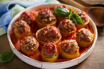 Zucchini stuffed with meat, rice and vegetables in tomato sauce. Loaded zucchini