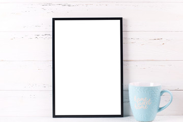 Empty black frame mockup and blue cup