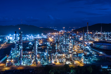 refinery oil and gas production industry and mountain with blue sky background at night