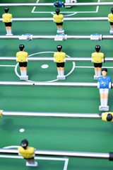 Table football, active game background, nice Bokeh. Sports game for children, mulricolored plastic figures. Relax and activity play, sport competition. Red and blue colors. Sport bar recreation theme