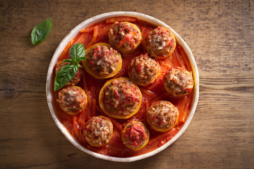 Zucchini stuffed with meat, rice and vegetables in tomato sauce. Loaded zucchini